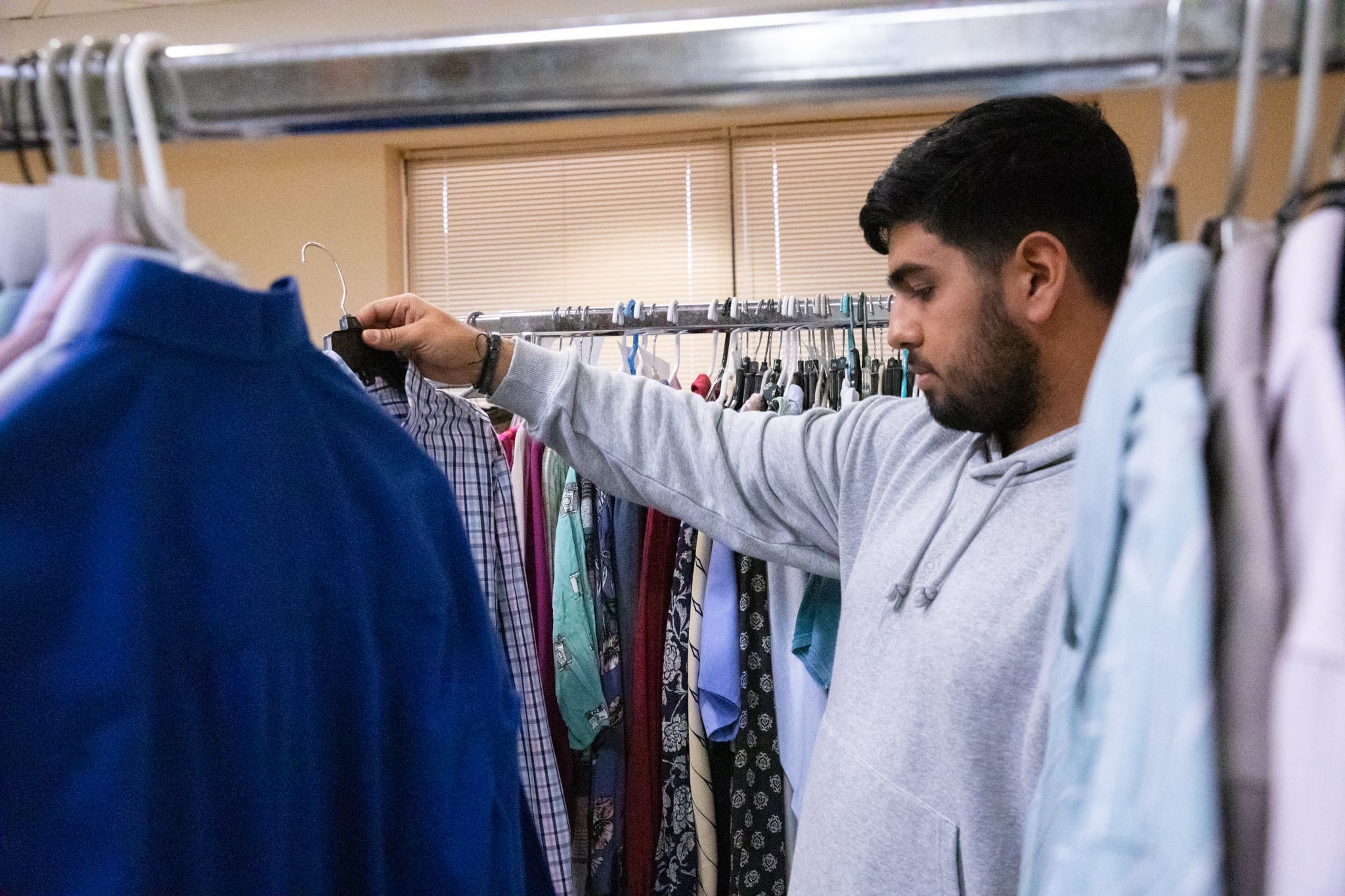 Student looking through clothes rack